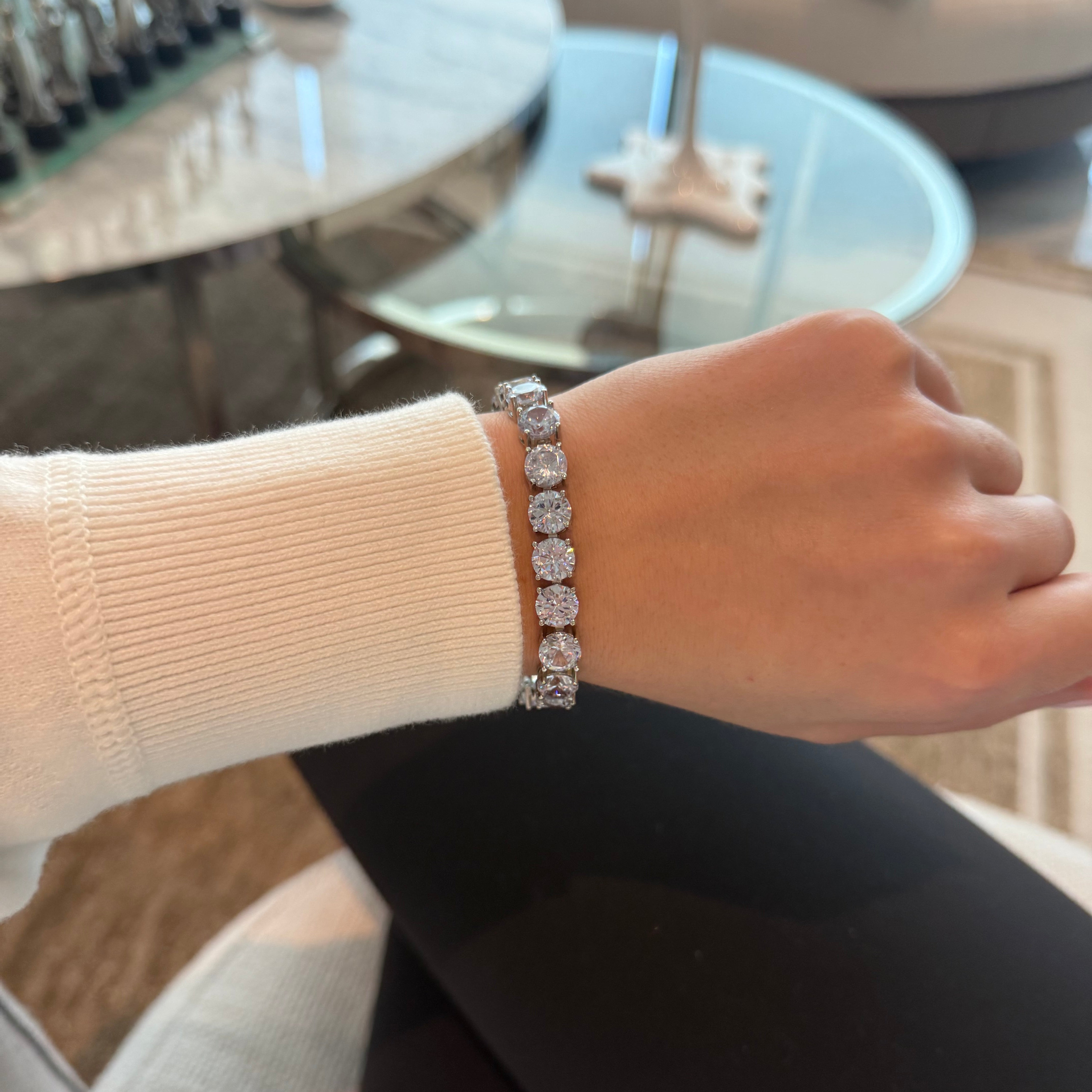 Close-up of a hand wearing a bracelet with a blurred background