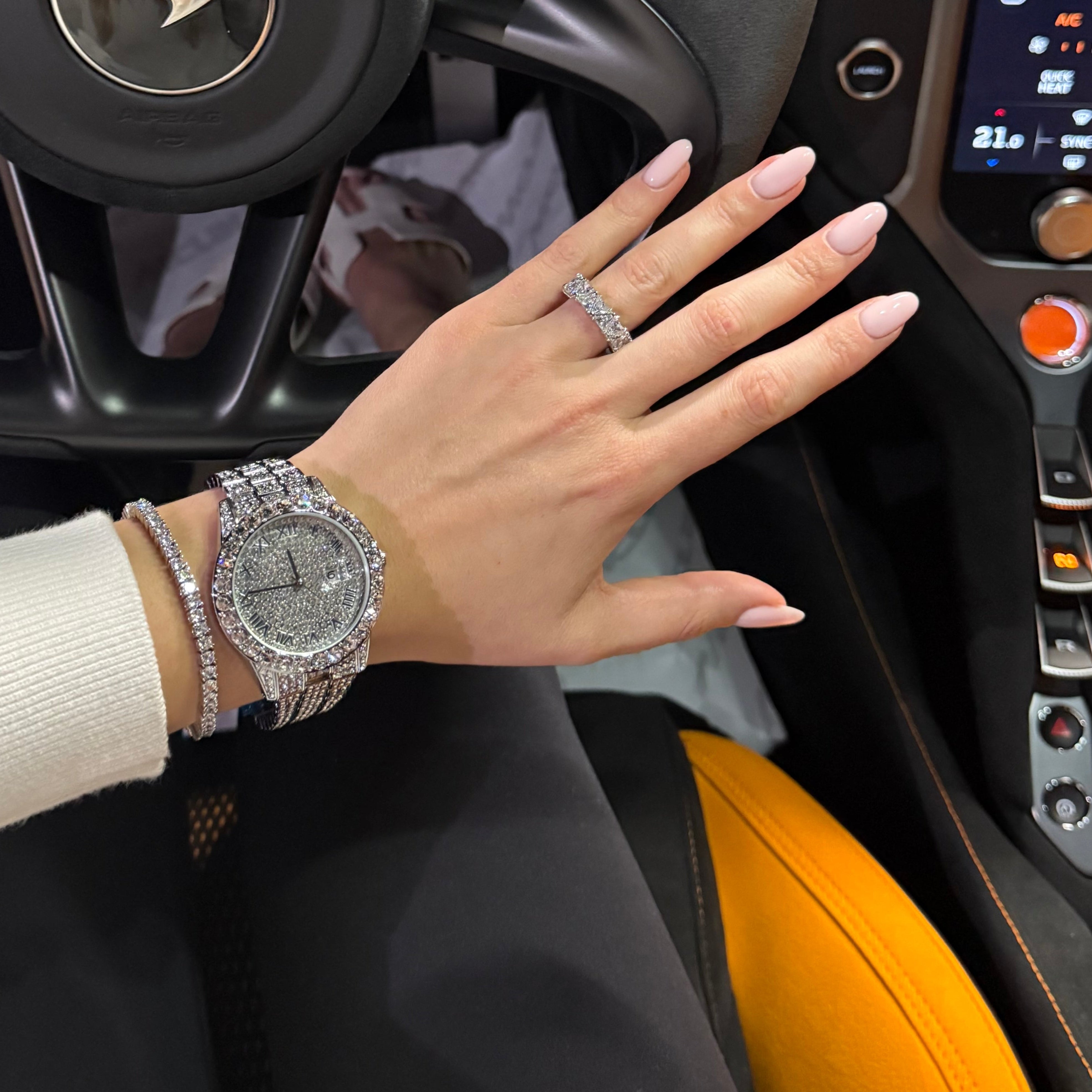 Hand with jewelry inside a car